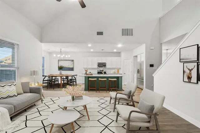 a living room with furniture and kitchen view