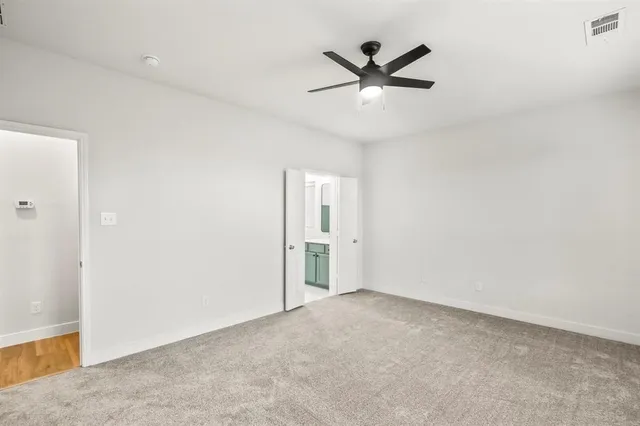 an empty room with closet and windows
