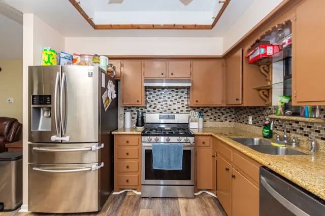 a kitchen with a refrigerator and a sink