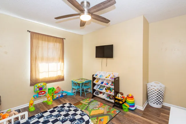 a bedroom with a bed a chandelier and a window