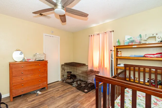 a view of a bedroom with furniture and a window