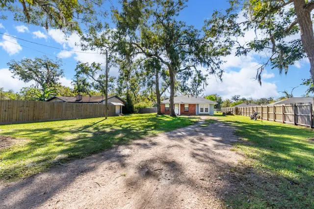 a view of yard with swimming pool and green space