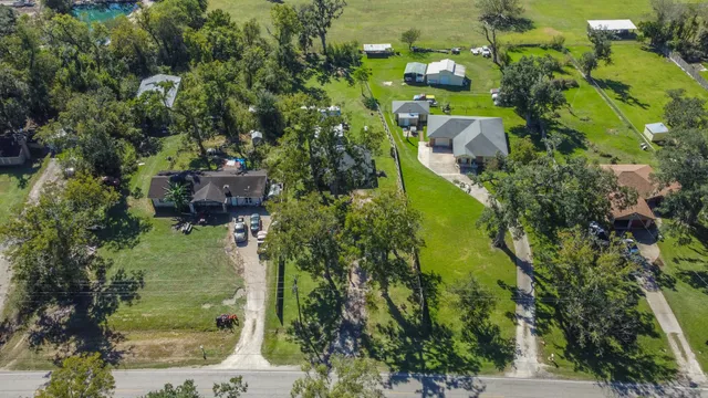 an aerial view of a house with a yard