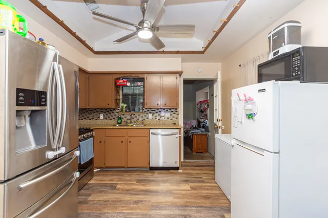 a kitchen with stainless steel appliances a refrigerator sink and microwave