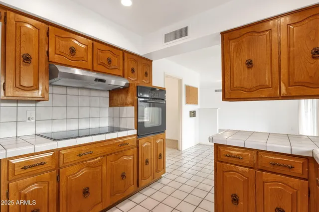 an empty room with a window and ceiling fan
