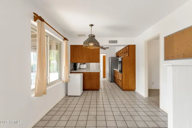 a view of a dining room with furniture and window