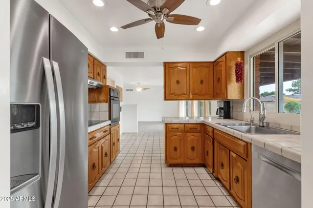 a kitchen with a sink window and cabinets