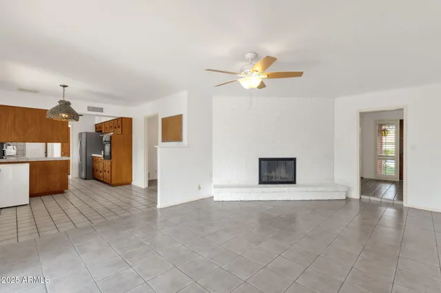 a kitchen with stainless steel appliances granite countertop a sink refrigerator and cabinets
