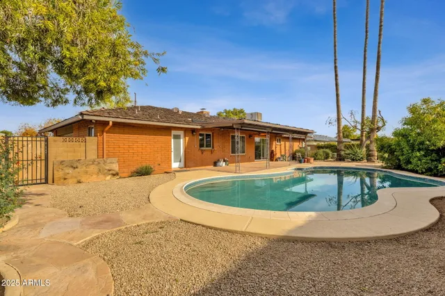 a view of a swimming pool with a yard