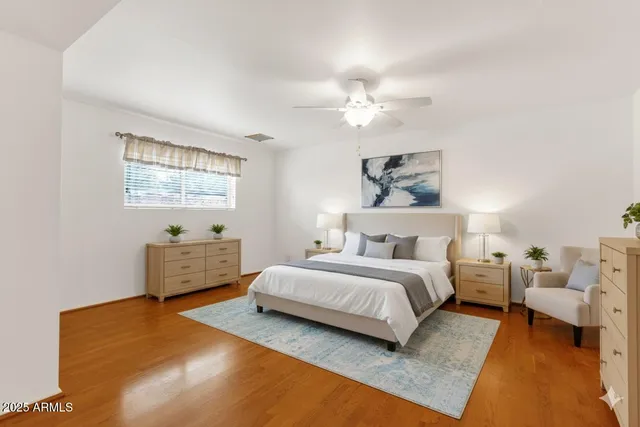 a view of an empty room with wooden floor and windows