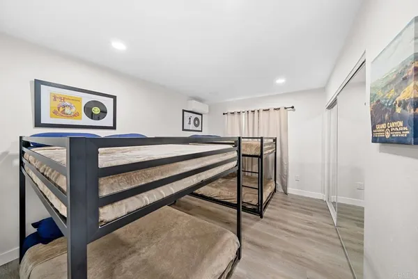 a kitchen with stainless steel appliances granite countertop a stove a refrigerator a kitchen island a dining table and chairs with wooden floor