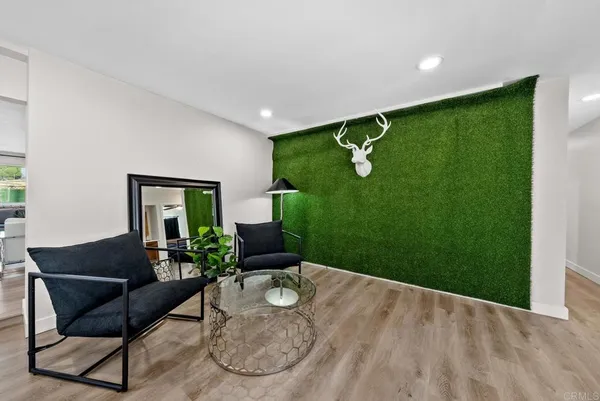a spacious bedroom with a bed and a flat screen tv
