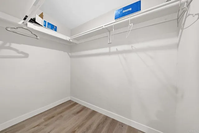 a view of a patio with couches table and chairs with plants and trees