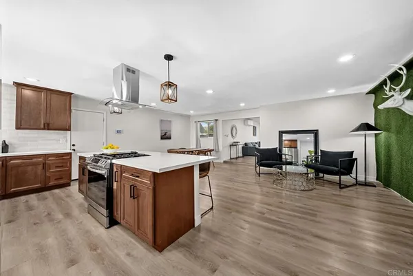 a kitchen with stainless steel appliances granite countertop a stove and a wooden floors