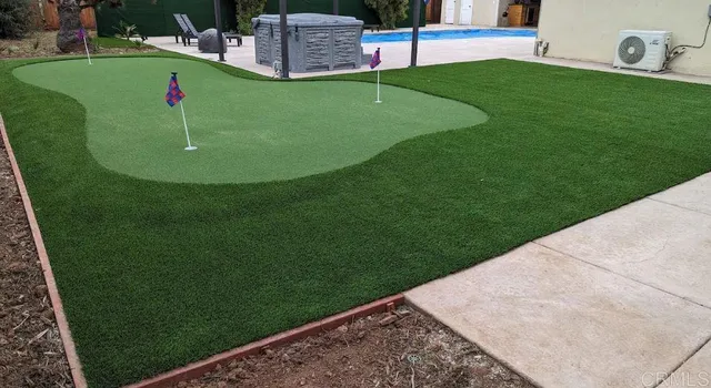 a view of a house with a yard and pathway