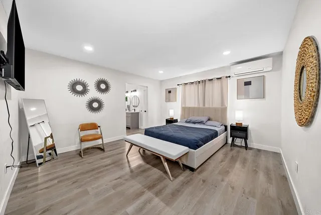 a bedroom with furniture and a wooden floor