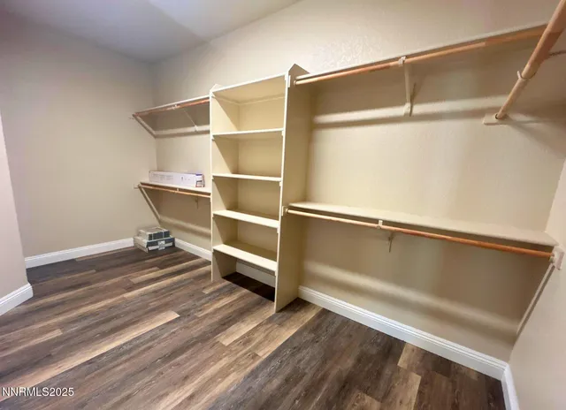 a view of walk in closet with empty racks
