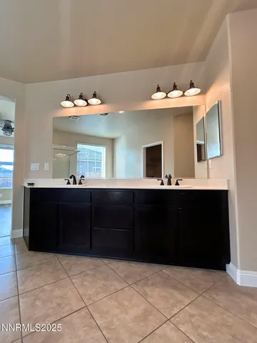 a bathroom with a sink vanity and a mirror