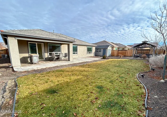 a front view of a house with patio yard and seating area