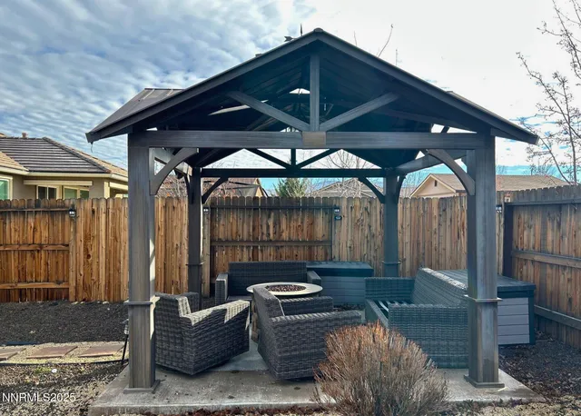 a backyard of a house with sofas table and chairs