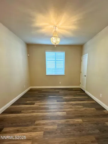 a view of a room with wooden floor and window