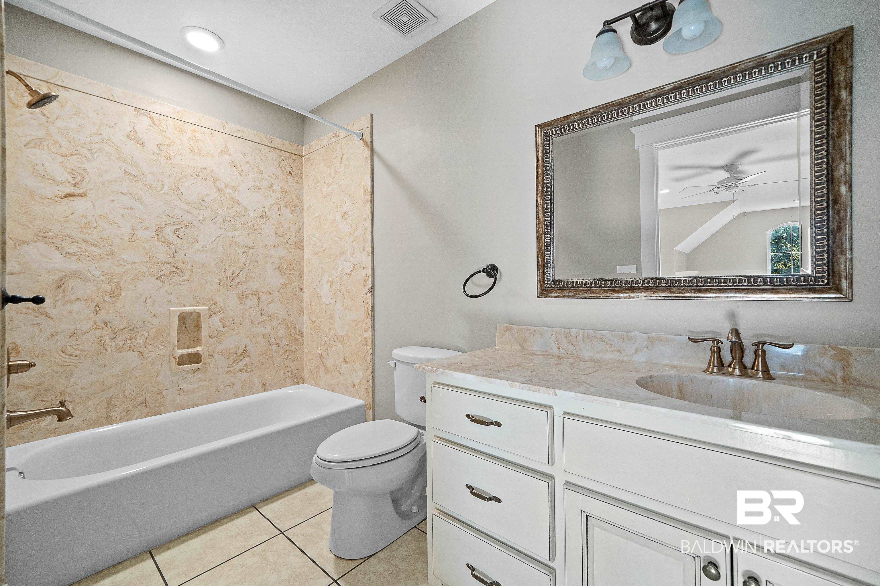 356 Liberty Street Fairhope, AL 36532 - Photo 28 of 39 Bathroom with shower / washtub combination, vanity, light tile patterned floors, and ceiling fan