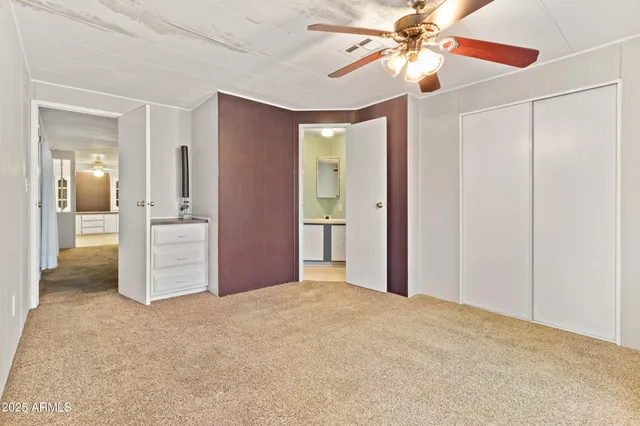 a view of a room with a ceiling fan and a window