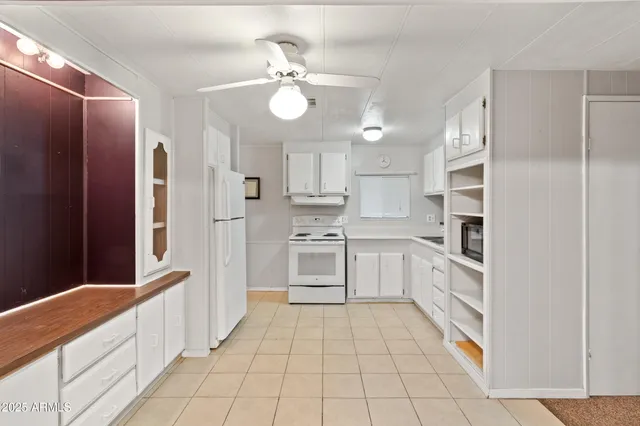 a kitchen with white cabinets and white appliances