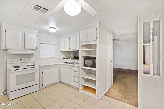a kitchen with cabinets appliances and a counter space
