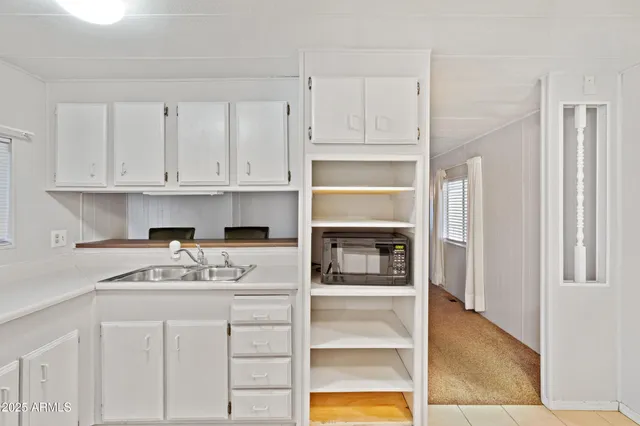a kitchen with granite countertop a stove cabinets and refrigerator