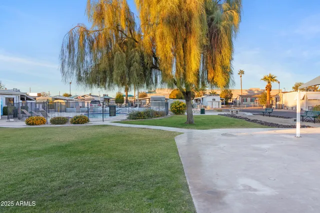 a view of a workspace with furniture and a bookshelf