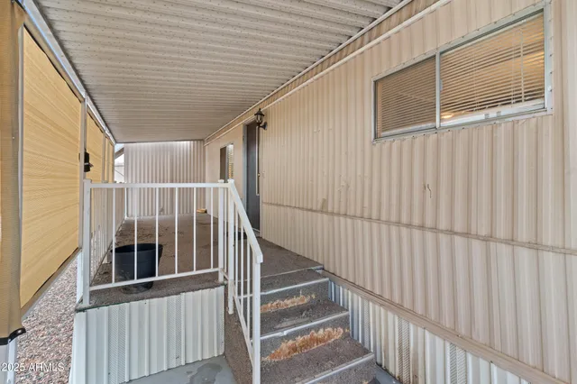 a view of staircase with wooden floor and white walls