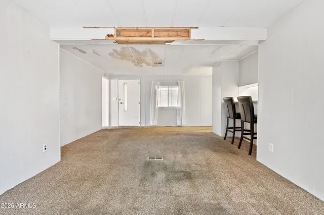a view of a livingroom with furniture and staircase