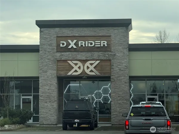a view of a brick building with car parked