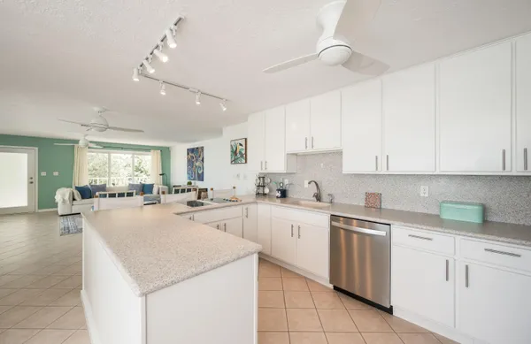 a kitchen with sink cabinets and view living