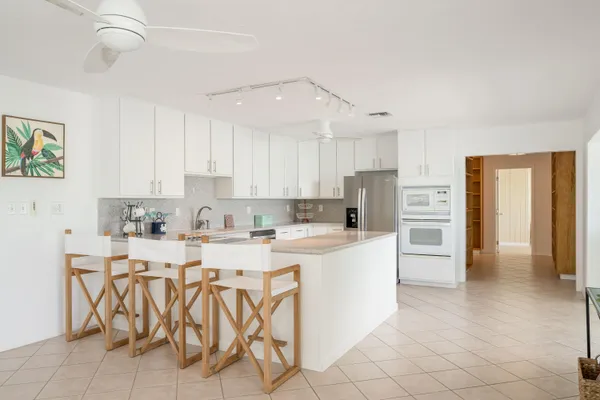 a kitchen with white cabinets and stainless steel appliances