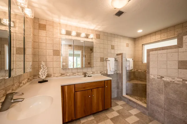 a bathroom with a double vanity sink and a shower