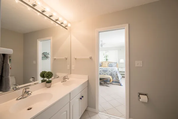 a bathroom with a double vanity sink and mirror