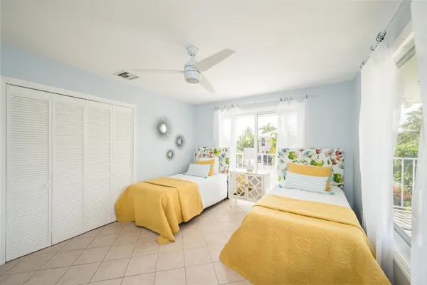 a bed room with two bed and a large window