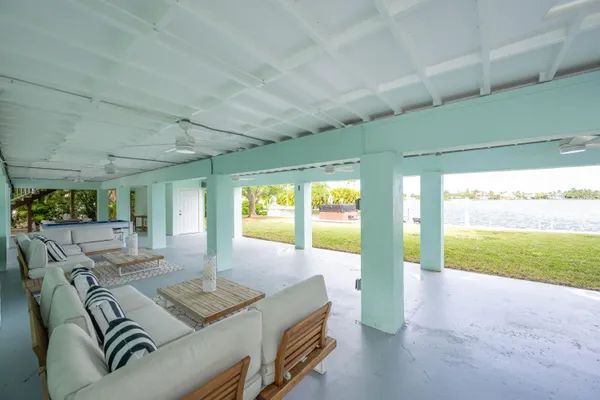 a room with furniture pool table and windows
