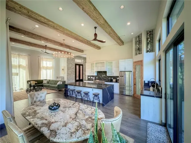 a large living room with lots of furniture and view of kitchen