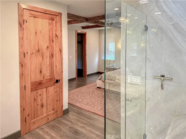 a bathroom with a shower and a glass door