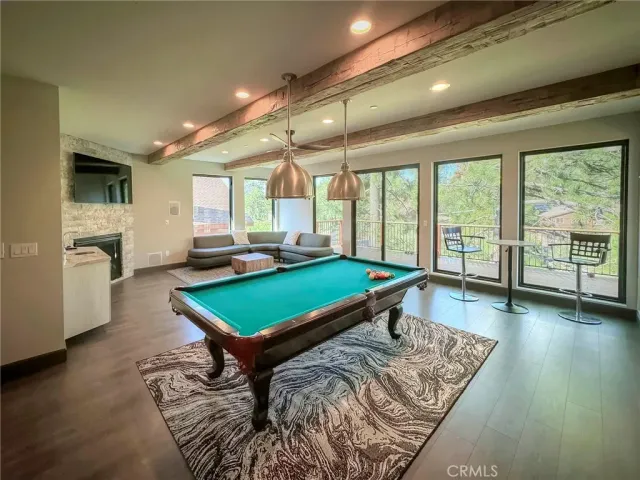 a room with pool table and windows
