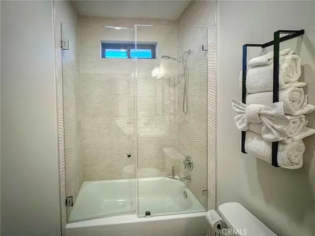 a bathroom with a bathtub and shower