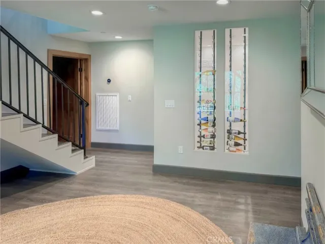 a living room with a bed and large window