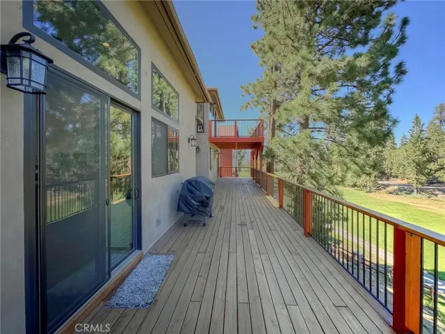 a view of a balcony with wooden floor