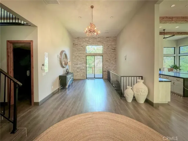 a view of a room with wooden floor and windows