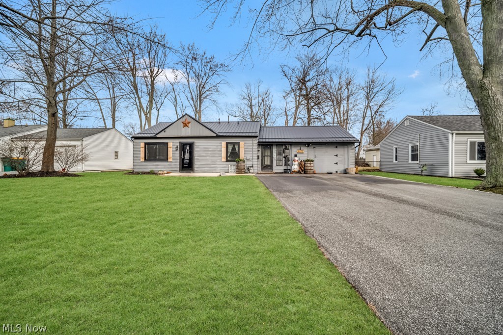 4875 Marigold Road Mentor, OH 44060 - Photo 1 of 27 View of front facade featuring driveway, a metal roof, and a front lawn