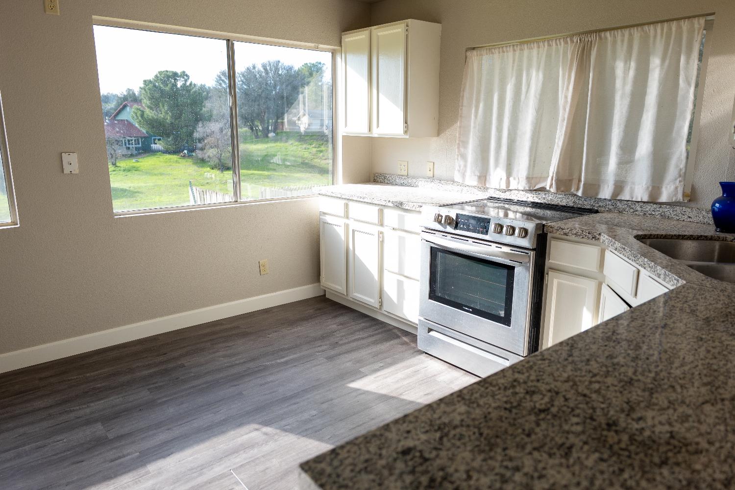 42560 Ranger Cir Way Coarsegold, CA 93614 - Photo 14 of 44 a kitchen with a stove a sink and a microwave