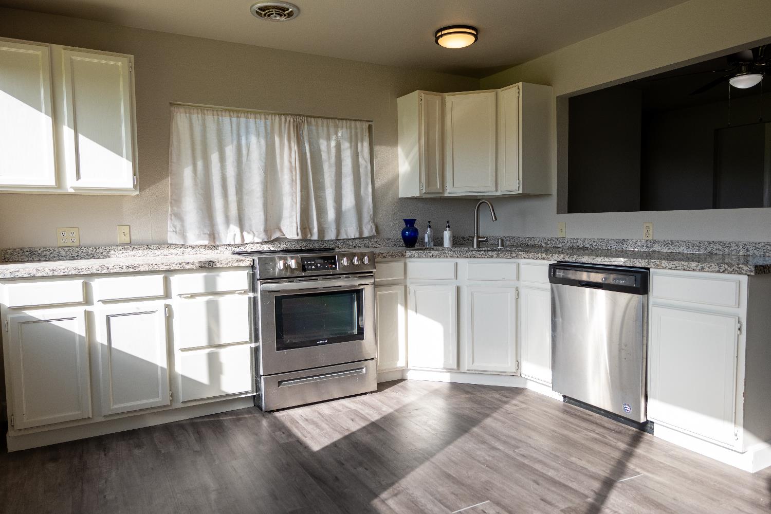 42560 Ranger Cir Way Coarsegold, CA 93614 - Photo 17 of 44 a kitchen with a stove a sink and a microwave